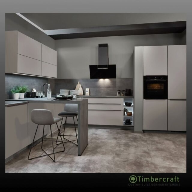 Sophisticated tones and seamless design 🩶

This contemporary kitchen features stone grey supermatt lacquered doors, paired with slate grey bar handles for a sleek monochrome finish. The Concrete Slate Grey reproduction worktop and splashback add depth, texture and an industrial-inspired touch.

Minimal, modern and effortlessly elegant.

🌱 Let your German dream kitchen come to life with Timbercraft custom-built German designs!

💡 Ready to elevate your space? Visit us at timbercraft.ie.

#germankitchen #modernkitchen #homedesign #kitchendesign #bespokekitchen