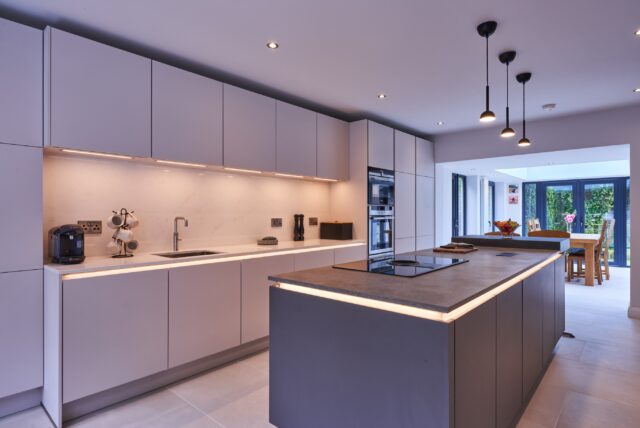 This Timbercraft Kitchens project showcases a contemporary two-tone grey German kitchen with sleek, handleless cabinetry for a clean and streamlined finish.

At the heart of the space, the island features an integrated venting hob, creating a practical and sociable area for cooking and entertaining. The ovens are neatly stacked at eye level within a tall unit, combining effortless functionality with a polished, modern look.

Built-in LED lighting in the handle track and beneath the wall units adds a warm, practical glow, highlighting the kitchen’s crisp lines and refined details.

Slick, contemporary and timeless — a kitchen designed for modern living.

Follow the link 🔗 in the bio to book your design appointment in our Newbridge or Dublin showroom today!

#TimbercraftKitchens #GermanKitchen #HandlelessKitchen #ModernKitchen #KitchenDesign KitchenIsland ContemporaryKitchen BespokeKitchen