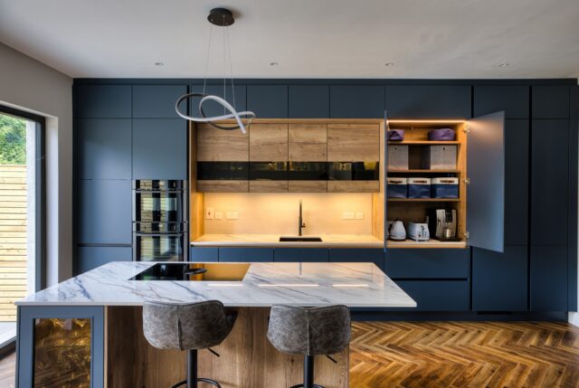 Rich blue, warm oak and clean, contemporary lines.

This recent Timbercraft project showcases our contemporary German kitchen range, pairing matt lacquered blue doors with oak accents for a balance of bold colour and natural warmth.

The handleless design creates a seamless finish, while marble-effect worktops bring subtle pattern to the space. A generous island with seating makes room for morning coffee, casual meals and catching up while dinner is underway.

Considering a contemporary kitchen for your home? Visit our showrooms or enquire through the link in our bio to start planning with the Timbercraft team.

#TimbercraftKitchens #GermanKitchens #ContemporaryKitchens #BlueKitchen #HandlelessKitchen KitchenIsland KitchenDesign IrishInteriors