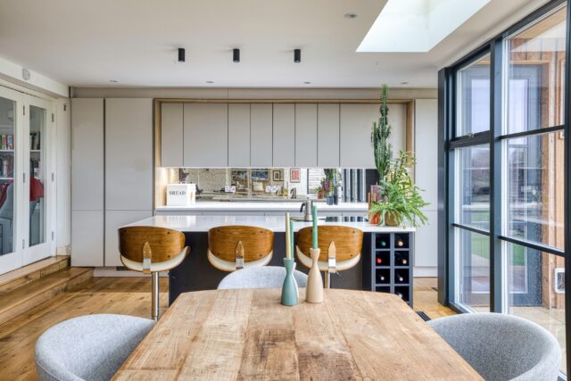 Natural light, warm textures and a seamless connection to the outdoors. 🌿

This recent Dublin project is designed around open-plan living, with overhead skylights flooding the kitchen with natural light and a full glazed wall opening the space directly onto the garden.

Warm wood-grain accents add depth and character, while a striking full-length antique glass splashback creates a beautiful feature along the sink wall, complete with a @quookerireland boiling-water tap.

At the heart of the kitchen, the generous island incorporates a @boracookingsystems venting hob, keeping sightlines clean and the space open. Bespoke open shelving extends the design into the dining area, providing practical storage and display space while helping the kitchen and dining zones feel like one considered interior.

And with greenery throughout, the planting brings another layer of colour, texture and life into an already light-filled space. 🌱

Thinking about a new kitchen or open-plan renovation?

Get in touch with Timbercraft Kitchens to start planning a space designed around your home and the way you live.

#TimbercraftKitchens #kitchensireland #KitchenDesign #BespokeKitchens #kitchendesignireland